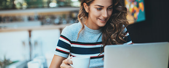 Woman reading blog with coffee